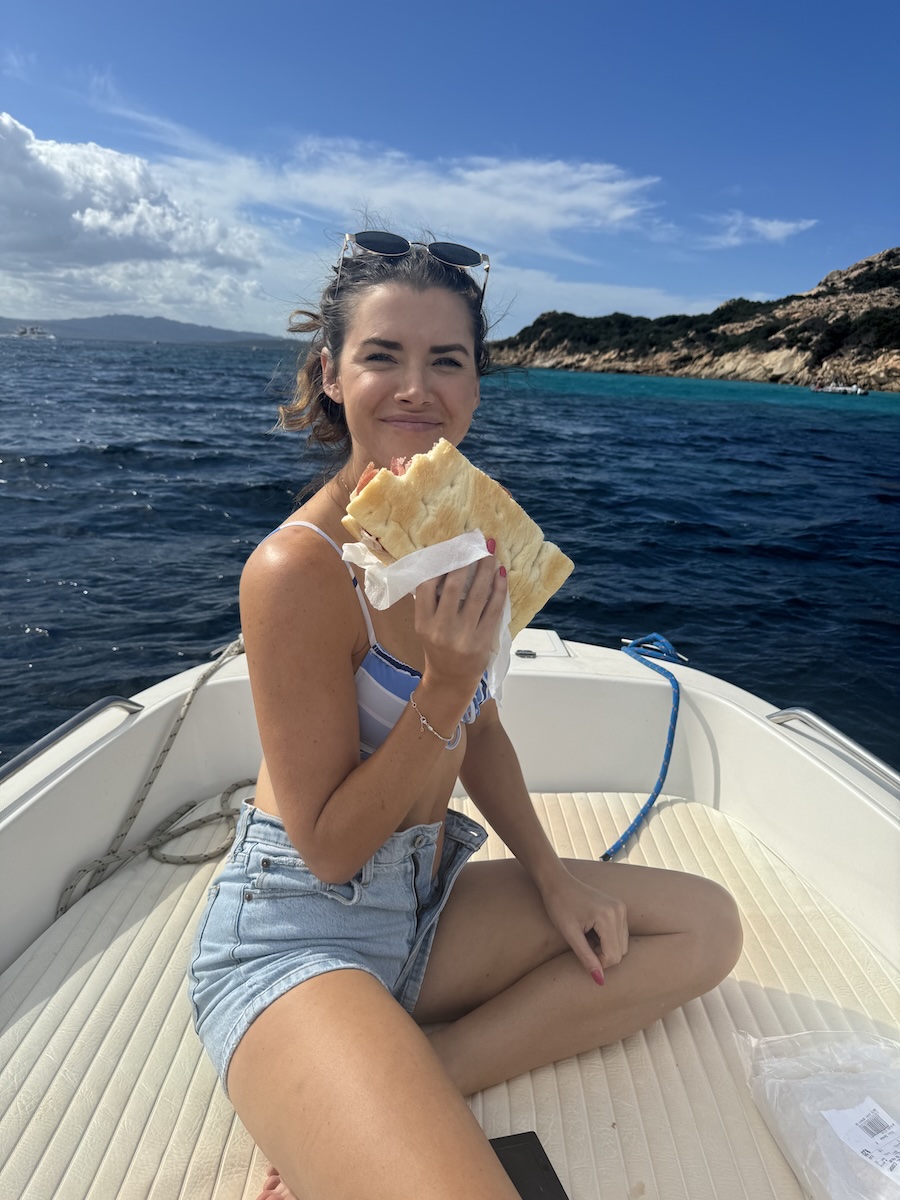 Enjoying a sandwich on a boat in Sardinia